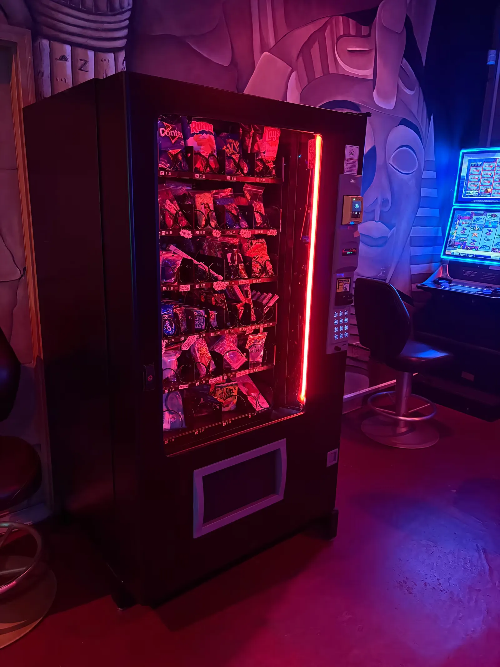 Stocked Boudoir Boxes machine glowing under red club lighting