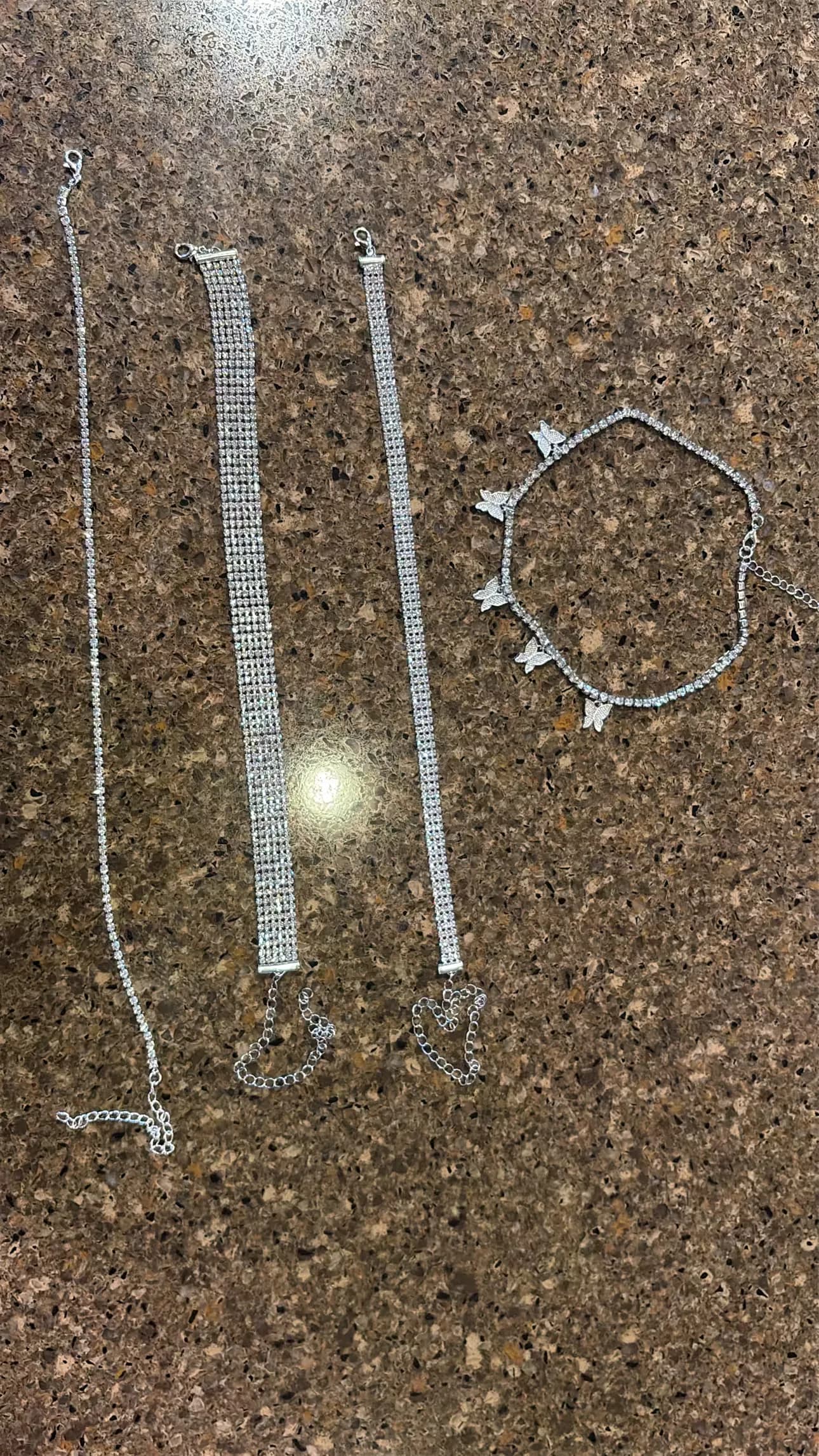 Rhinestone chains and a bracelet laid out for the jewelry row