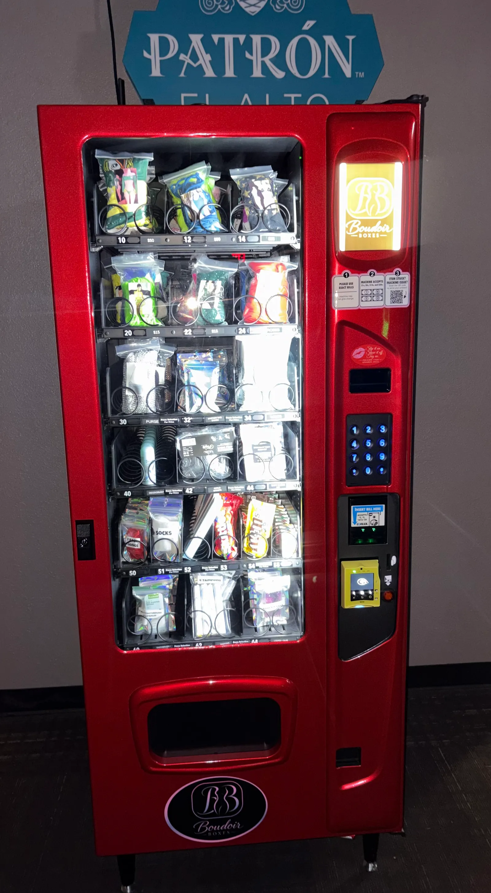 Fully stocked Boudoir Boxes machine seen straight on, showing product rows, keypad and payment panel